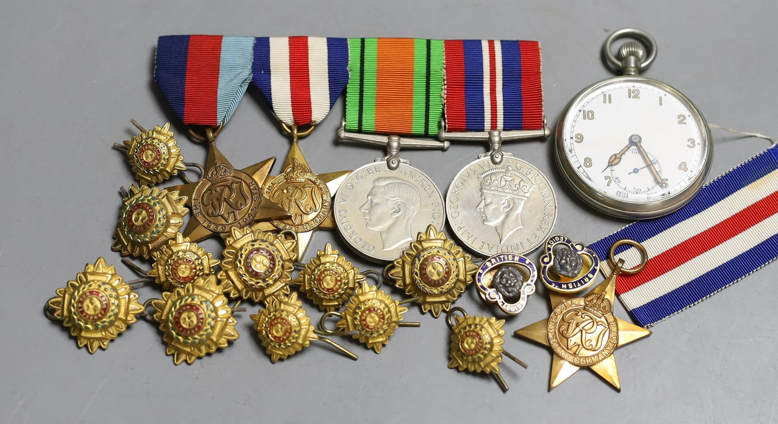 A group of five WW2 medals, together with a selection of cap badges and a pocket watch